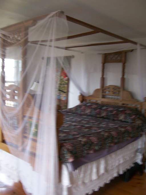 The British Raj room. Antique canopy bed with mosquito netting.