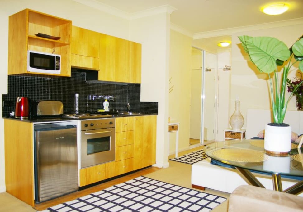 Fully equipped kitchen with cook-top stove, oven, microwave, fridge/freeze, kettle, 4 slice toaster, bowls, plates, cutlery, cups etc