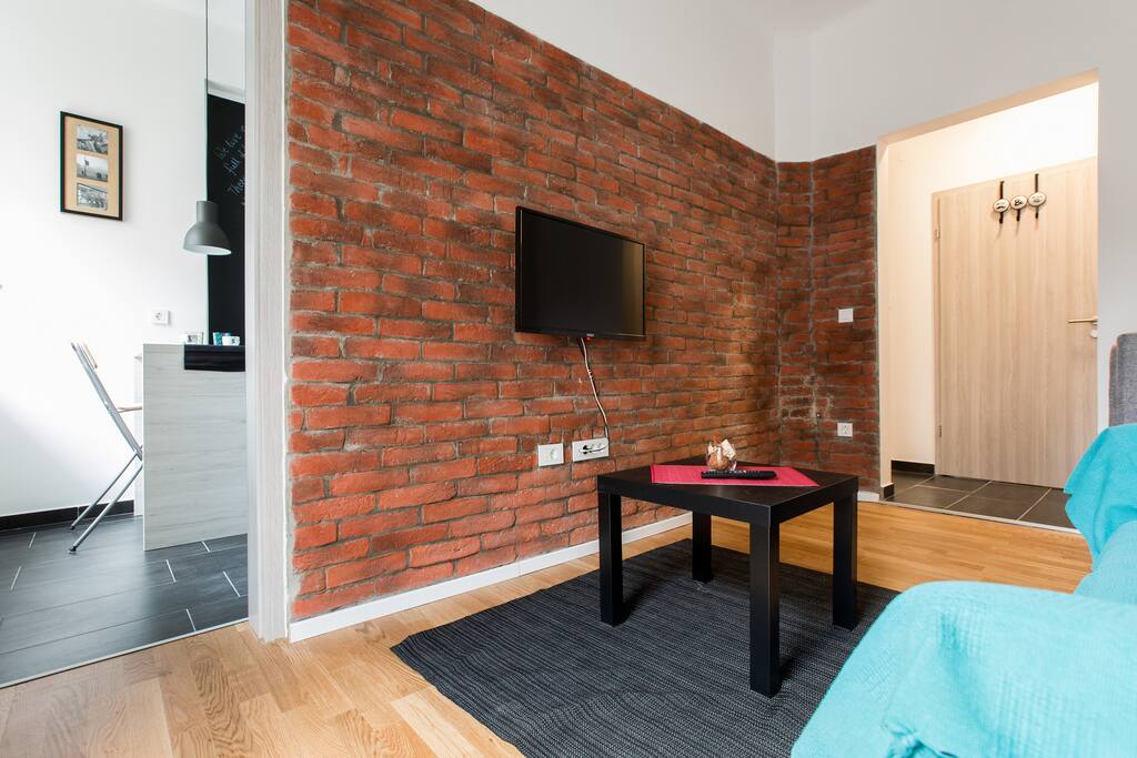 Look from the living room to the kitchen on the left and to the entrance hall on the right.