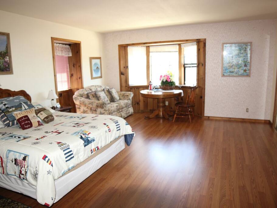 Master bedroom with queen sized bed with TV.