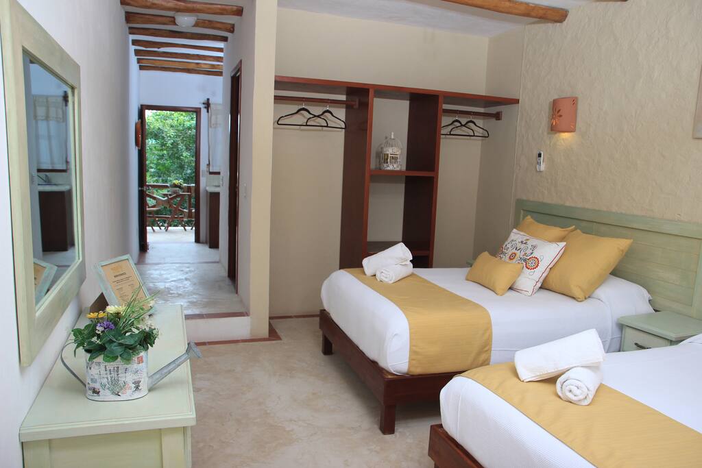 Room with closet, kitchen and private bathroom.
