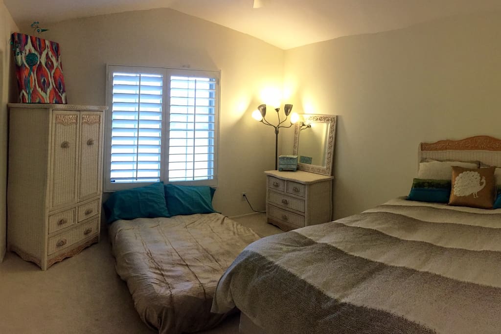 Queen bed & double, queen, & twin mattresses available. Closet space. Right off the entrance way next to a private guest bathroom.