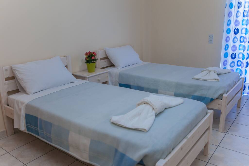 Twin bedroom with light airy colours