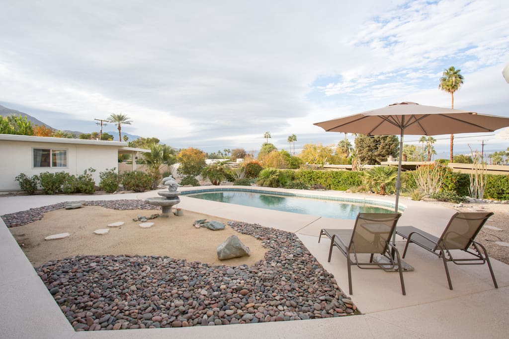 The huge pool with patio furniture