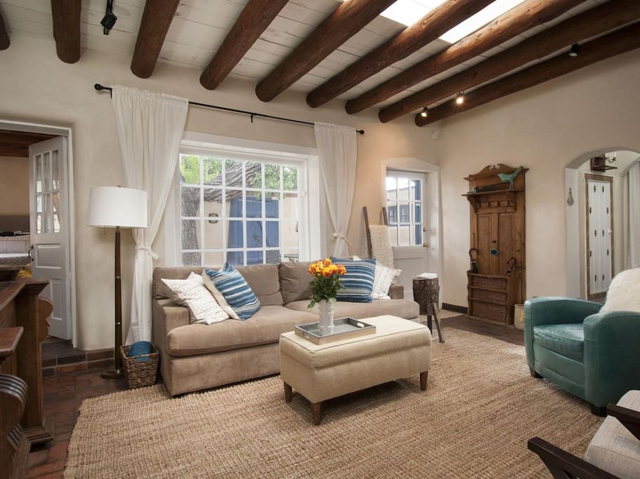 Large living area with fireplace, large 4K flat screen TV. Living area opens to private courtyard with BBQ grill