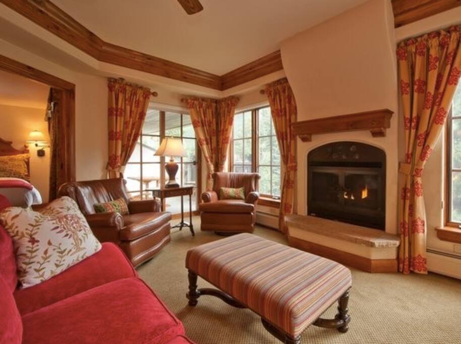 Spacious living area with fireplace and mountain views
