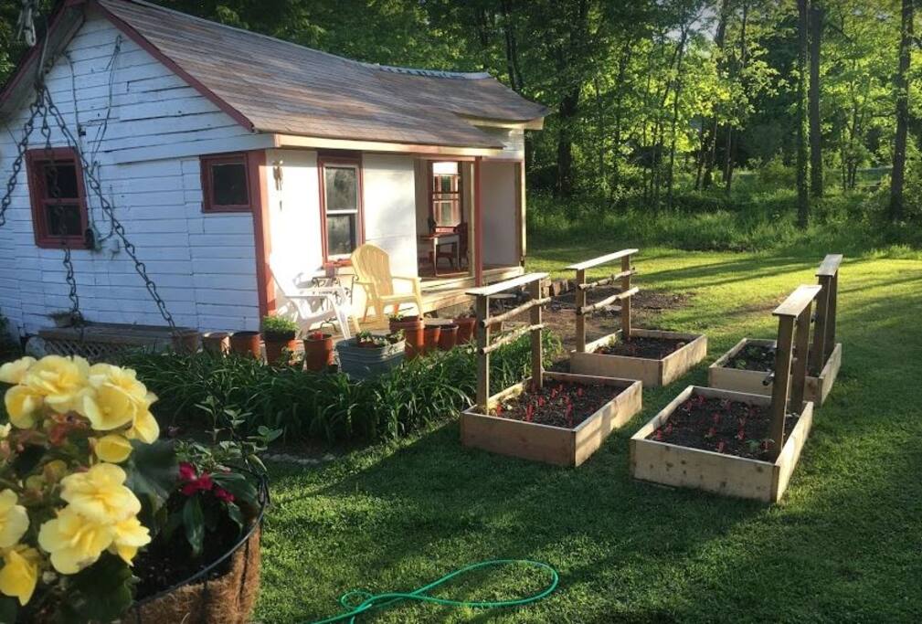 The white bungalow was recently converted into an open air dining portico. The planters are now growing organic heirloom veggies, for our guests