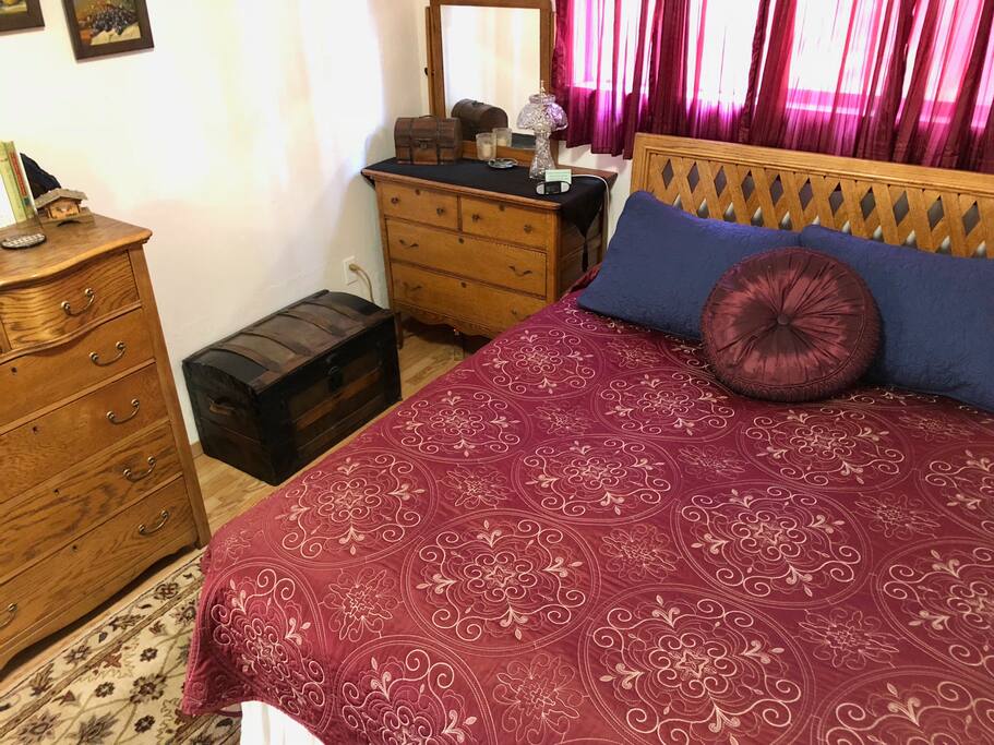 The queen bed with antique oak furniture