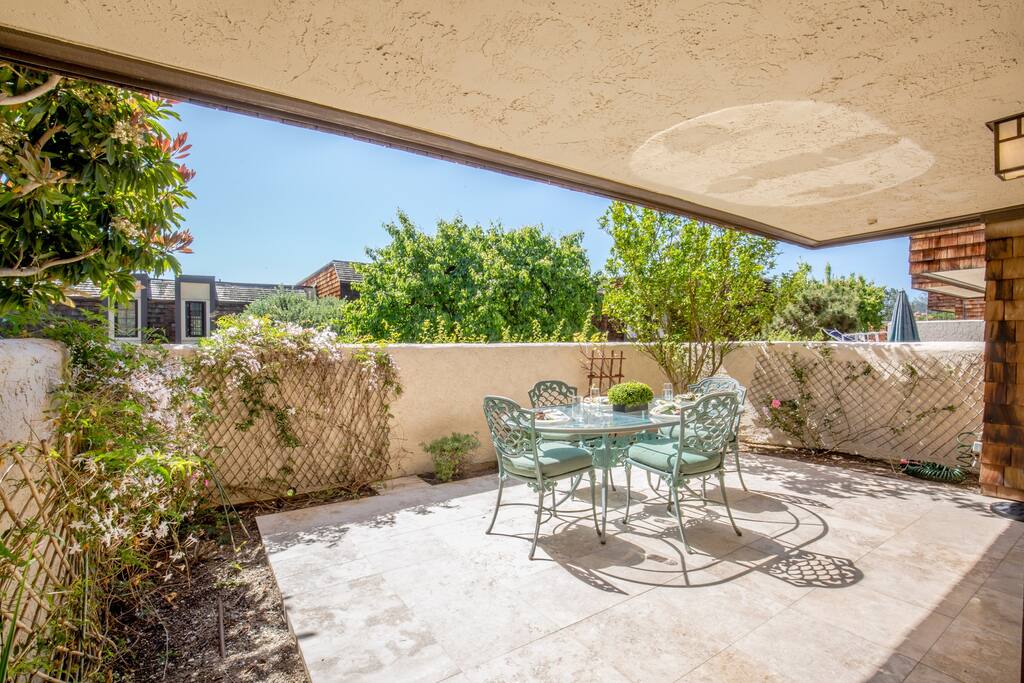 Large Patio area off of Downstairs bedrooms with Patio Table chairs and umbrella.