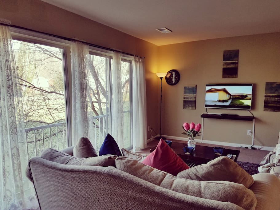 Cozy living room with floor to ceiling windows for a wonderful view.