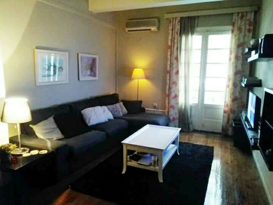 Living room, corner couch, air-conditioned, wooden floor