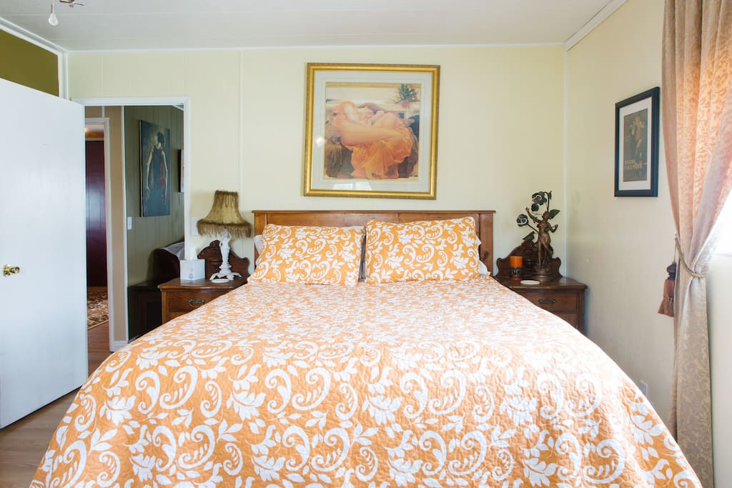 Queen bed, twin mattress on floor for 3rd person.