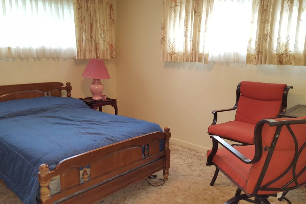 Large bedroom with table and closet.