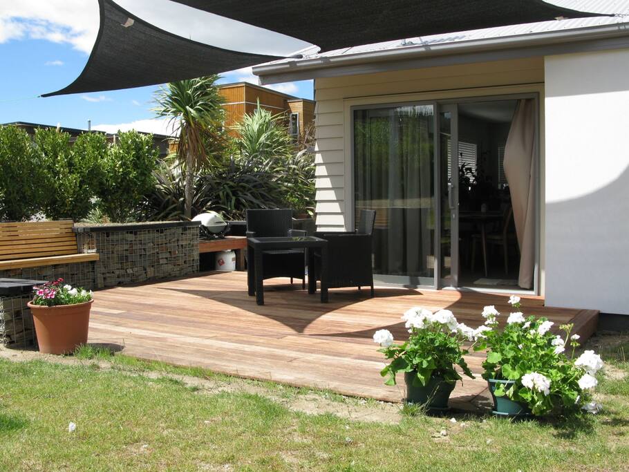 Indoor/Outdoor area with BBQ and seating, all under shade sails.