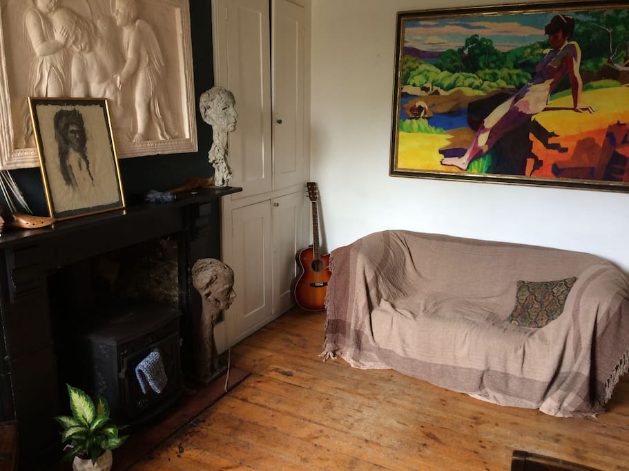 Comfortable sitting room where there are books, a television or guitars for guests to enjoy