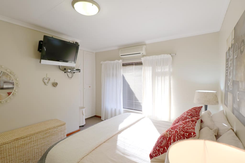 Wonderful, crisp master bedroom with small sea view from windows