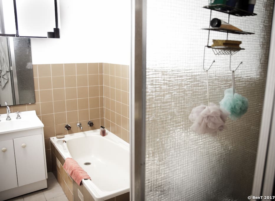 Bathroom with bath, shower, washing machine and dryer