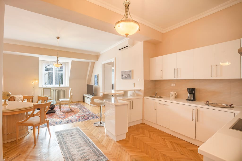 The kitchen in the foreground and the living room in the background