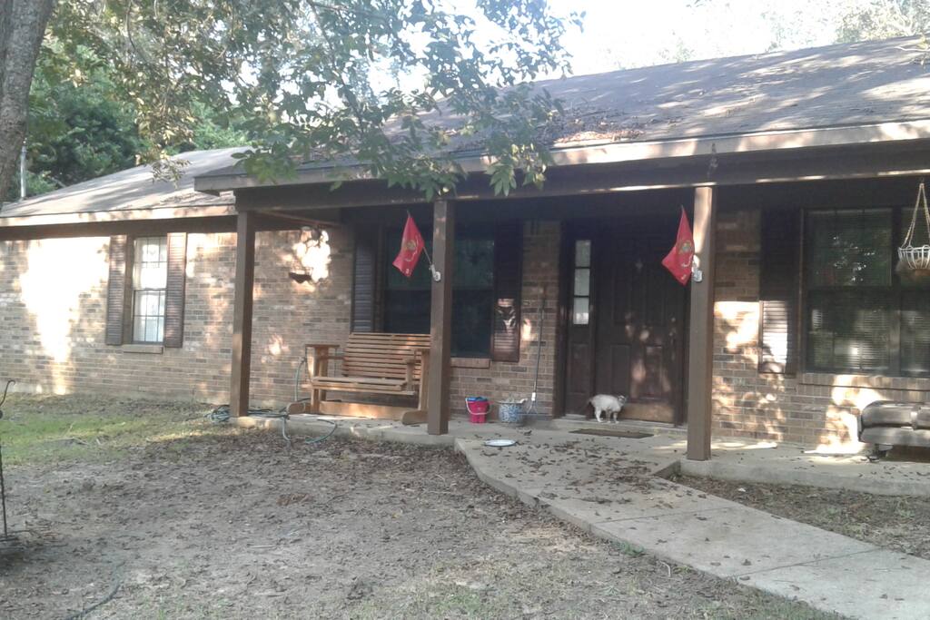 brick home with concrete driveway and sidewalk