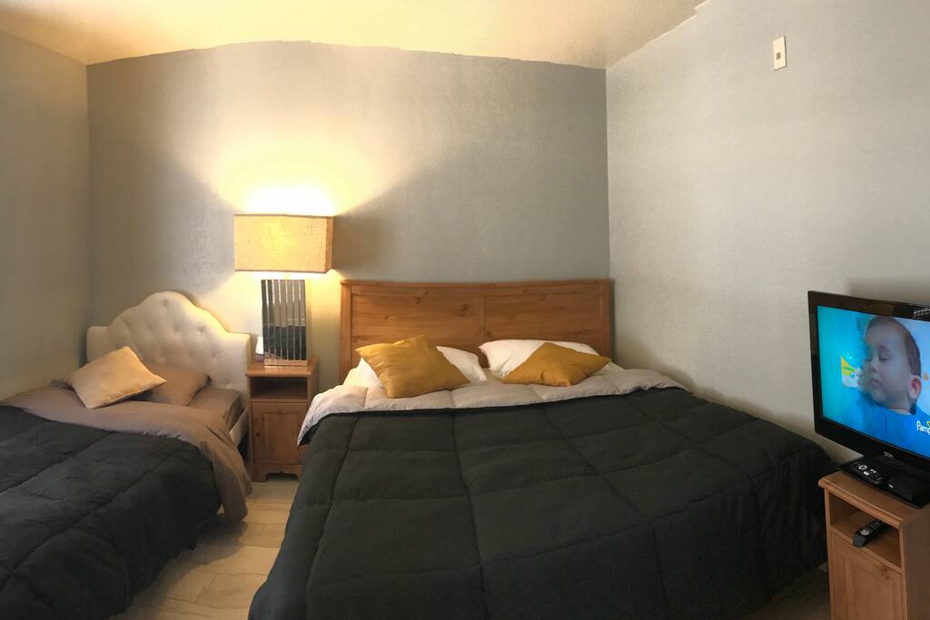 Master bedtoom with Queen amd Twin Bed and TV