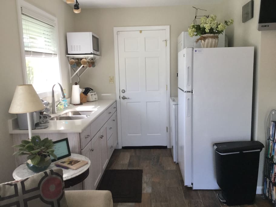 Kitchenette with full size refrigerator, microwave, toaster, k-cup beverage brewer, indoor grill, single burner stovetop, double sink, utensils, dishes, and linens provided. Washer/dryer too!