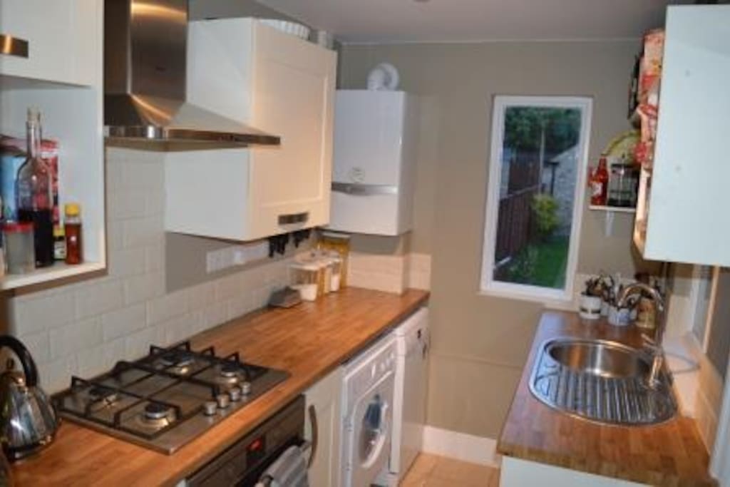 Cute kitchen with door and windows onto the garden. Washer/drier and dishwasher
