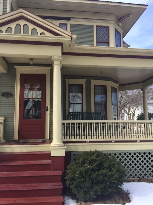 Refurbished historical Victorian home with wrap-around porch and swing.