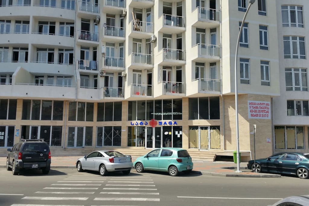 The second balcony to the left, on the second (on top fo the shop) floor.