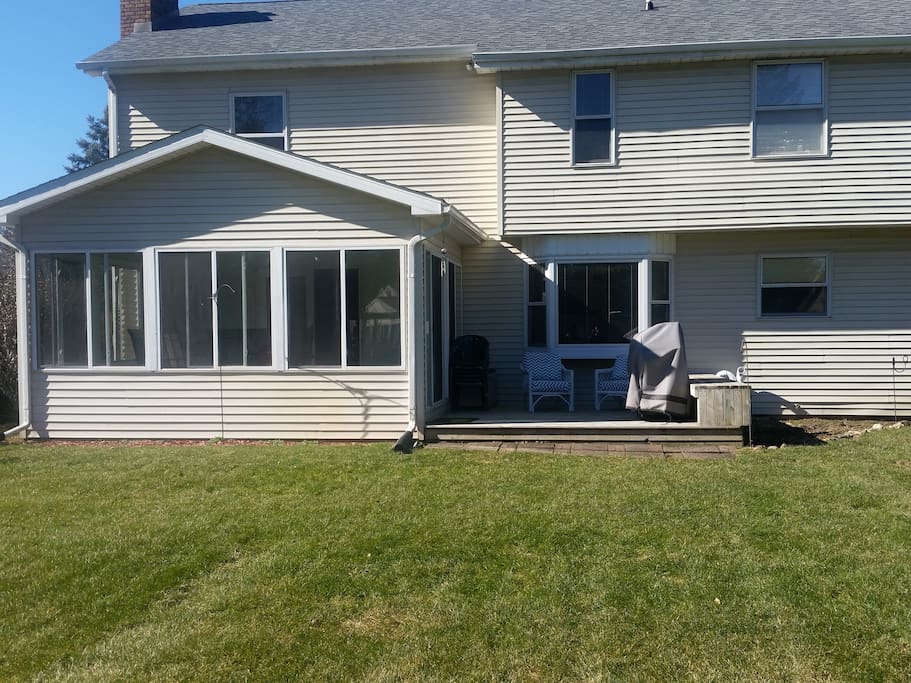 Three season room, deck, and gas grill.