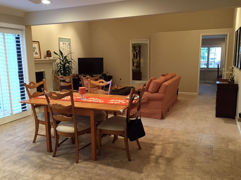 Large open living area with dining table which seats 6.