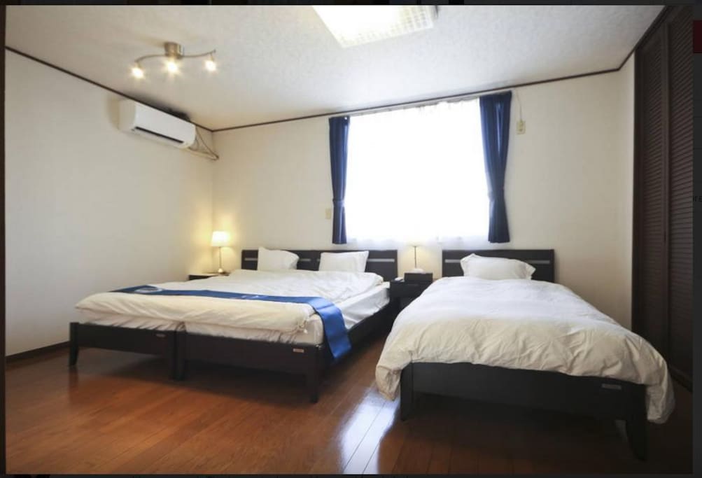 Master Bedroom with king sized bed and a single bed. Extra futon can be requested.