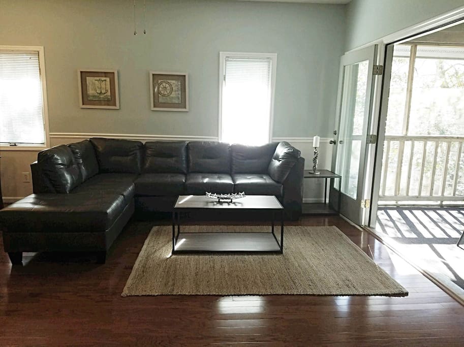 Living Room; Leather Sectional, 50" LED Smart TV, French Doors open to screened-in patio.