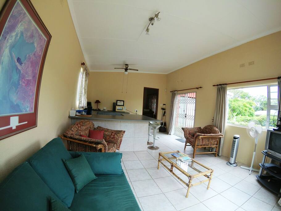 Interior of flat with kitchen at far end and door to bedroom