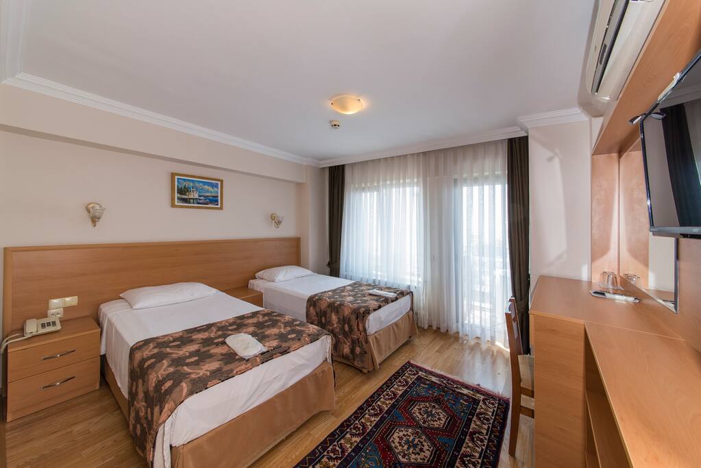 Clean, comfortable, modern room. Air-conditioned & Furnished with comfortable beds. A minibar supplied with complimentary water & mineral water. LCD TV with international satellite channels, bedroom slippers and standard toiletries, a hair dryer & free Wi-Fi connection. Daily cleaning. Laundry & Ironing service for a small extra cost. Non-smoking rooms. Charming street view.
