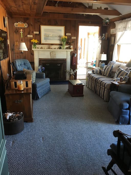 Warm and cozy living room in Cape Cod style with HDTV