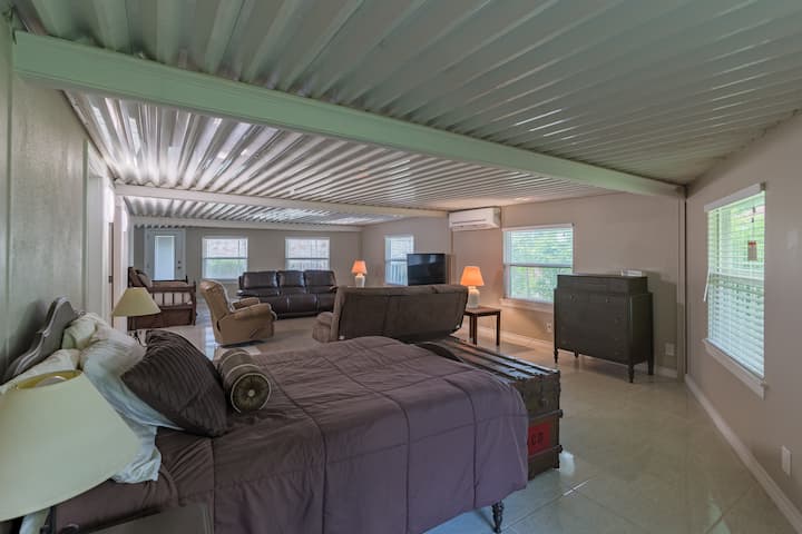 Large back recreational room takes up the whole length of the villa.  This space has a designated family room space  with couches and tv,  as well as three sleeping areas.  There is a full bed, full futon, and a twin bed. It also has a 
1/2 bath.