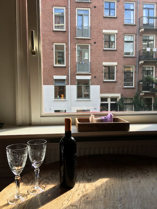Enjoy a glass of wine and a typical Amsterdam view