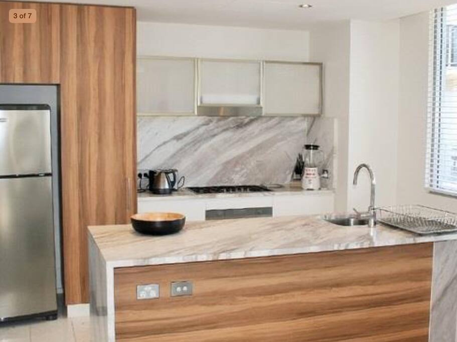 Kitchen with full sized fridge and oven