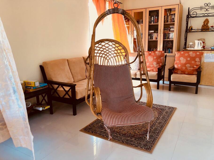 The spacious carpeted LIVING room, has a 3-piece sofa-set and 2 puffies comfortable for a group of 8 people. Windows have Garden view.