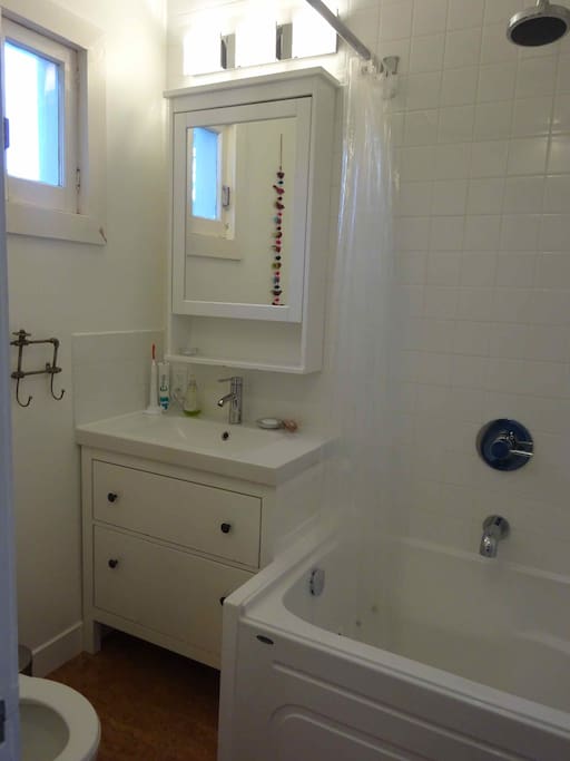 Updated bathroom with deep tub and rain shower