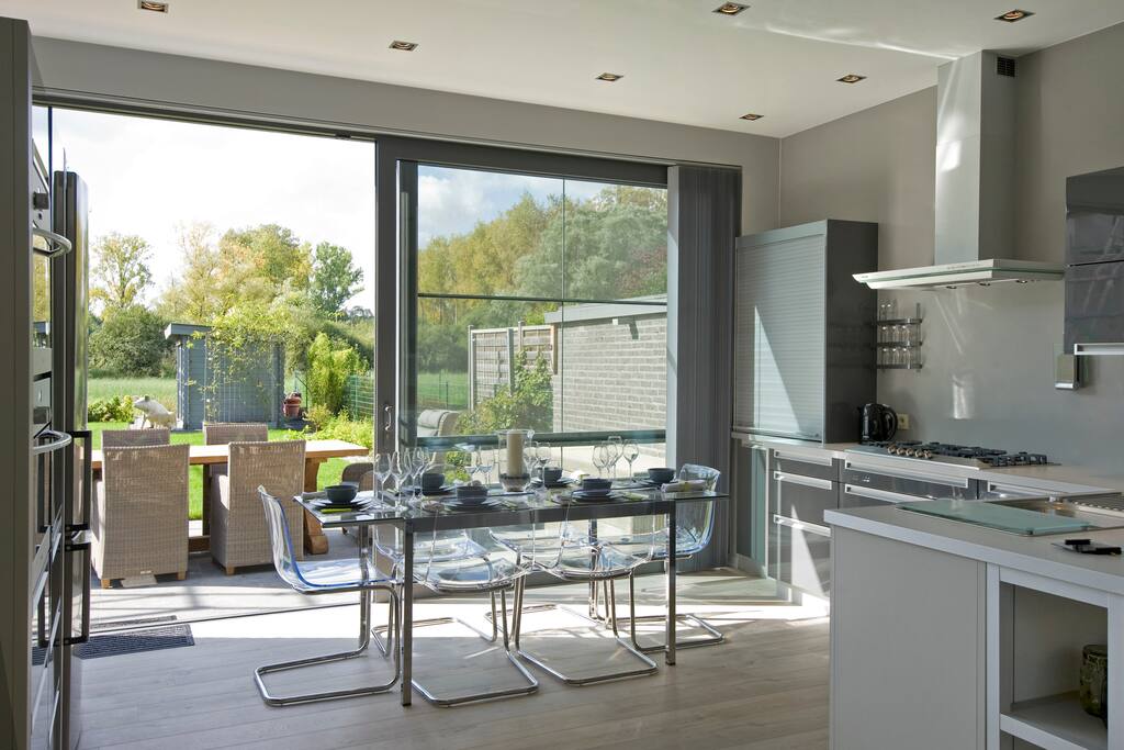The kitchen features all the mod-cons you could want: a dishwasher, combi oven, steam oven, gas cooker, two fridges, a freezer, and a dining table for six people.