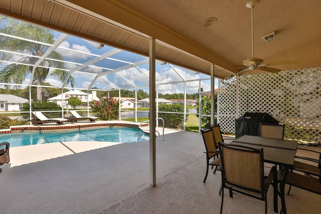 Spacious outdoor area with solar heated pool, beach chairs, BBQ grill, and a dining area.