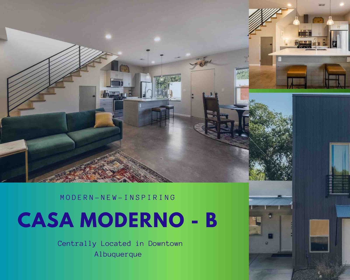 A modern living space featuring an open floor plan with a green sofa, a dining area, and a kitchen with sleek appliances. Natural light enters through large windows, highlighting the contemporary design. The exterior view shows a multi-story building with distinctive architecture.