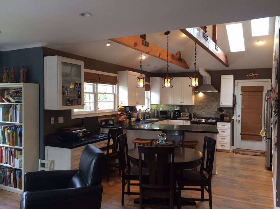 Open floor plan, modern kitchen with granite counters.