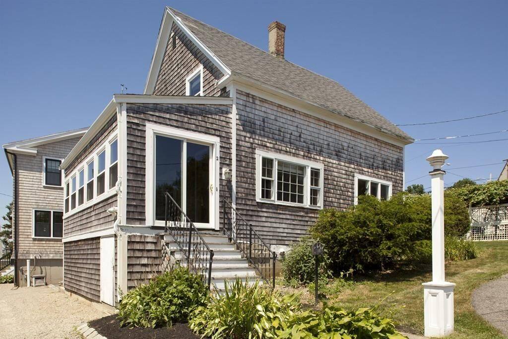 Side of house, including 3 season porch with window views facing bay water