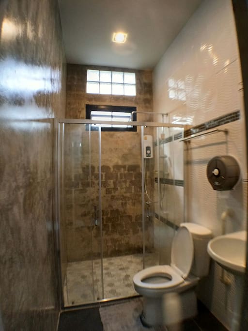 Shared bathroom with rain shower and warm water.