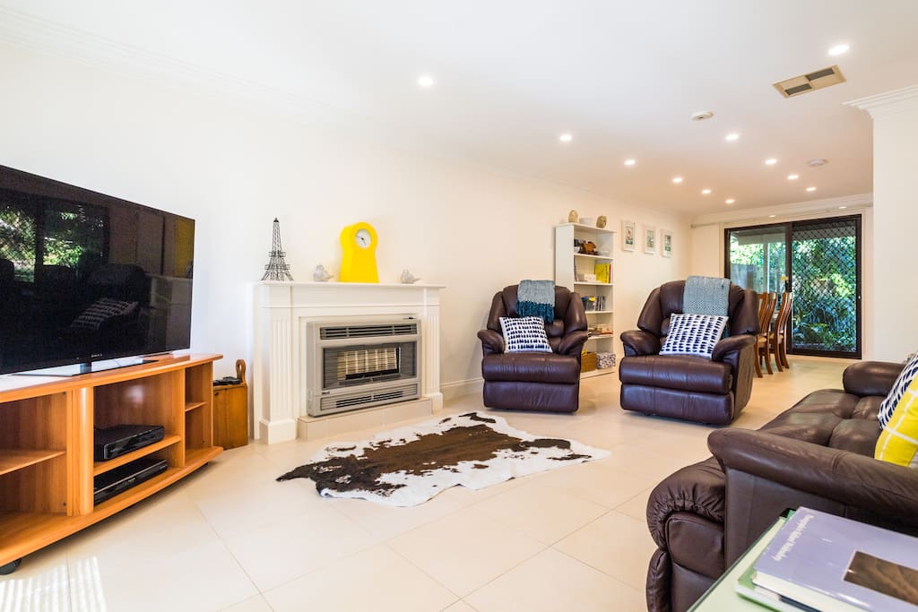 Open plan family dining room with large flat screen TV