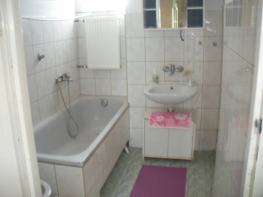 bathroom with bath and shower, separate toilet