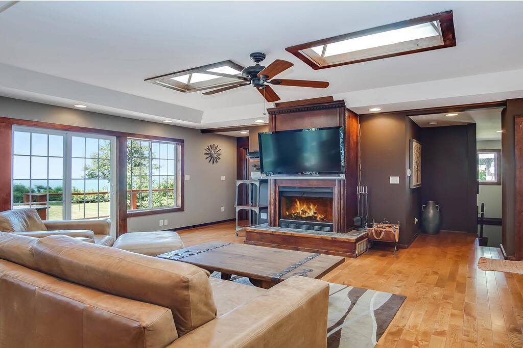 The living area is bright with windows overlooking the lake.
