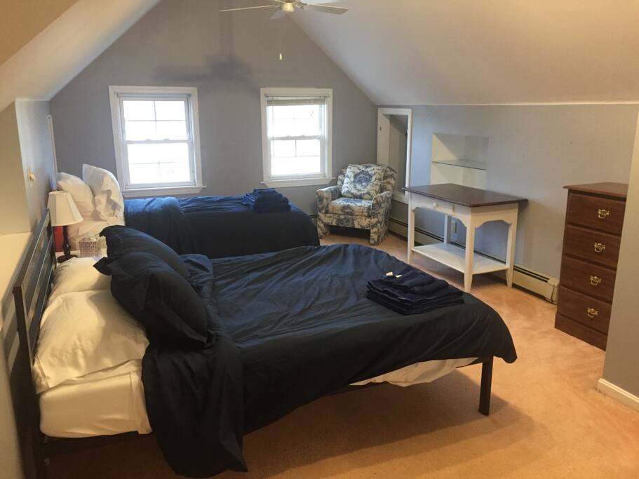 Top floor has two beds, a twin and a queen, as well as a private bathroom with a shower. Computer desk not pictured.
